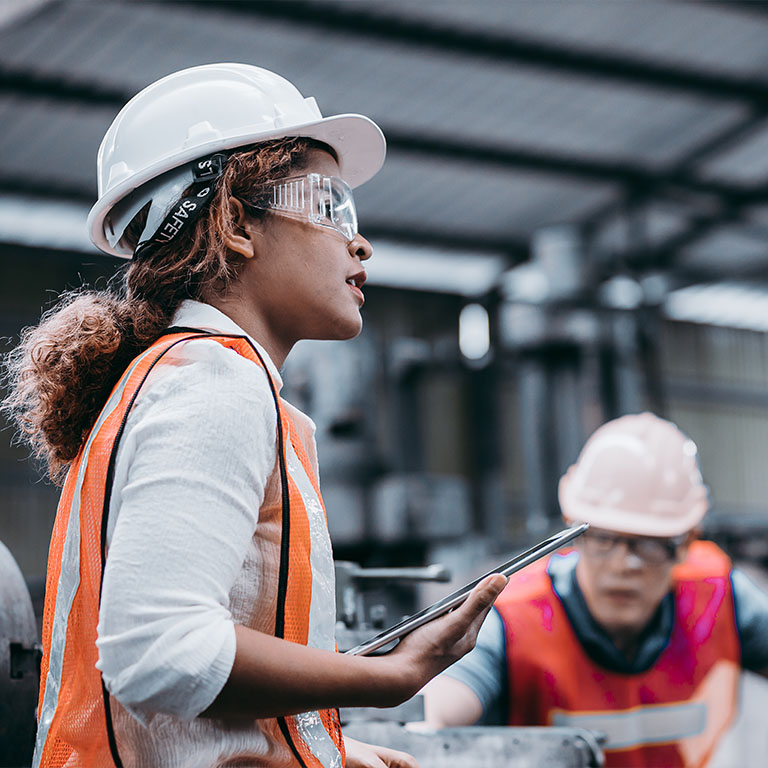 female worker on construction site wearing protective gear