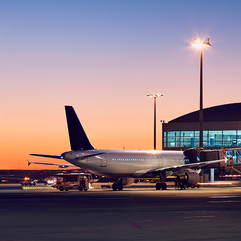 Preparation of the airplane before flight. Airport at the colorful sunset.