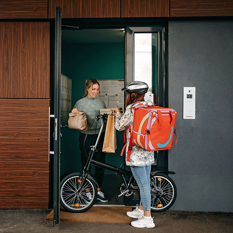 Young women working in delivery service